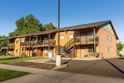 the exterior of an apartment building with balconies and stairs