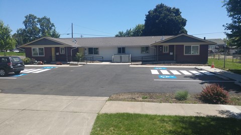 an empty parking lot in front of a house