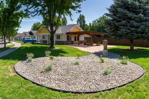 a round rock garden in front of a house