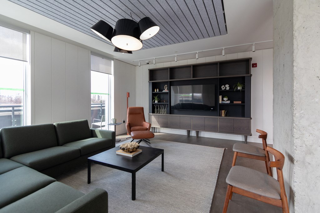 a living room with a green couch and a television