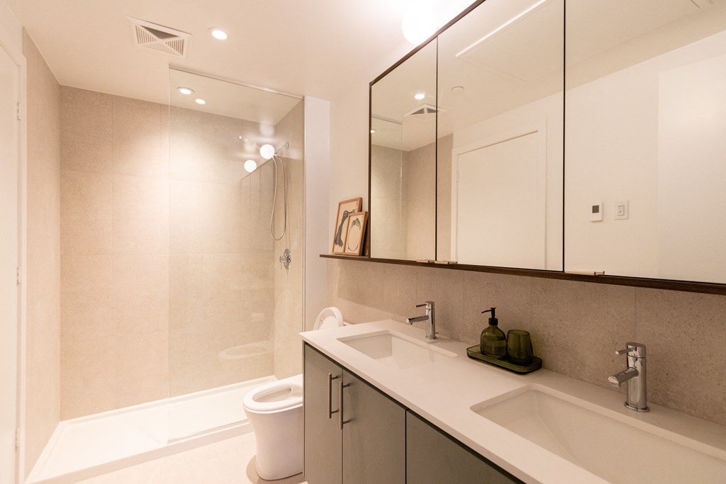 a bathroom with a sink and a toilet and a shower