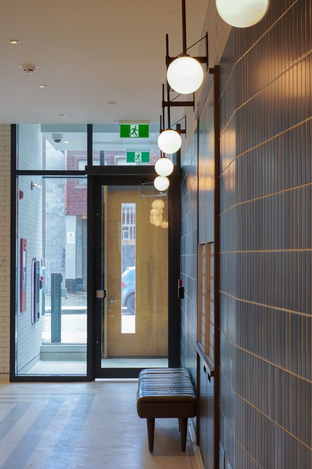a view of a lobby with a door and a bench