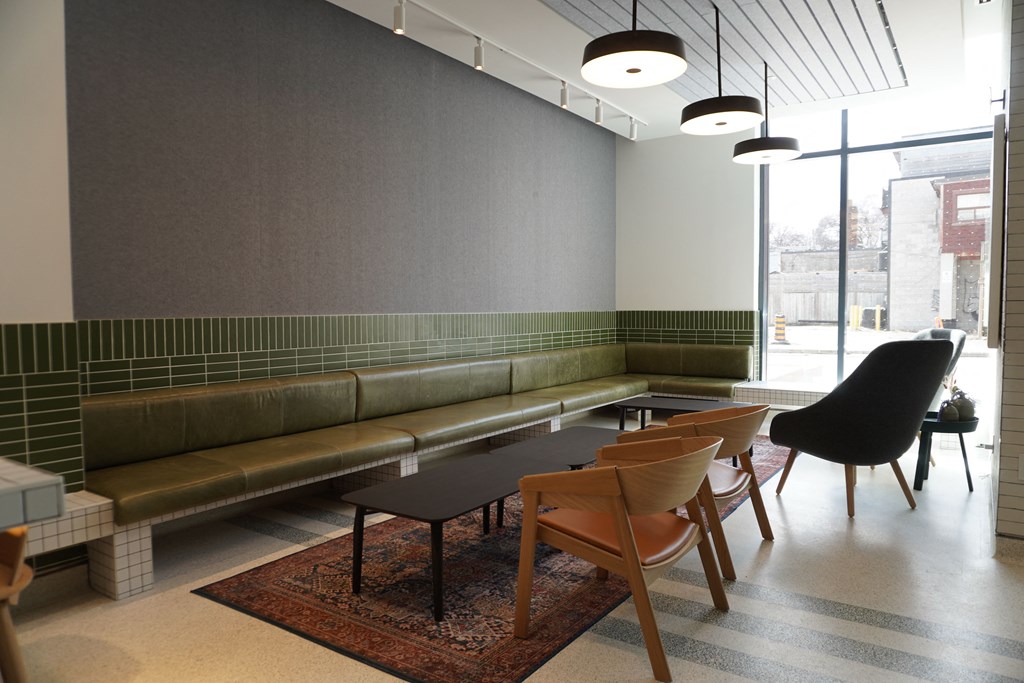 a seating area with a table and chairs in a lobby