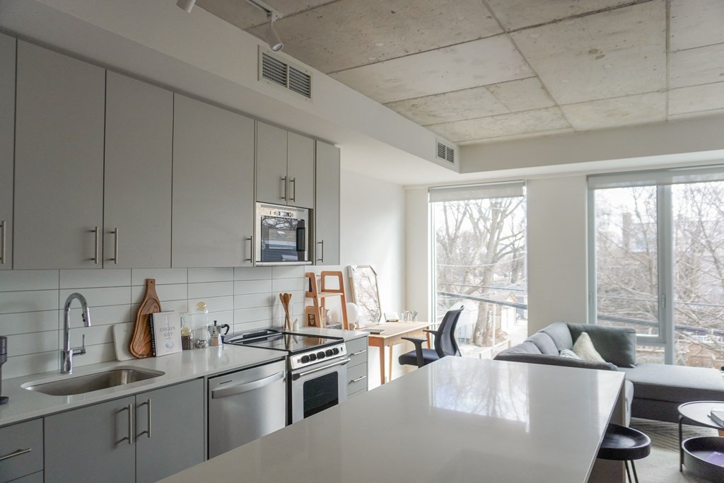 an open kitchen and living room with a large window