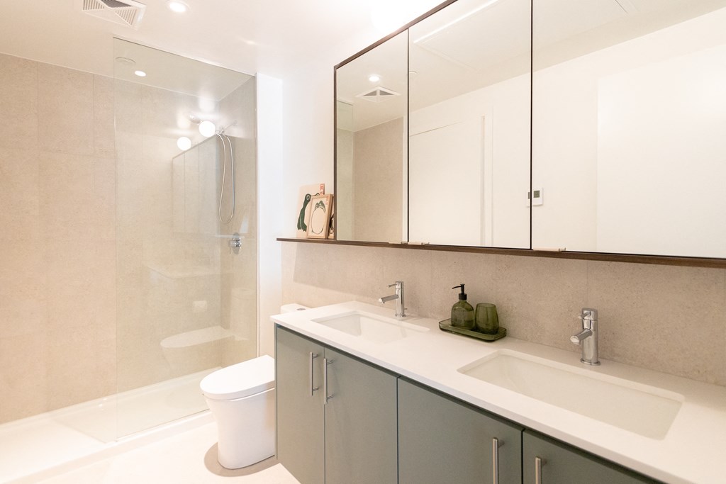 a bathroom with a sink and a toilet and a shower