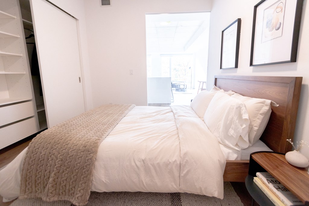 a bedroom with a bed and a large window