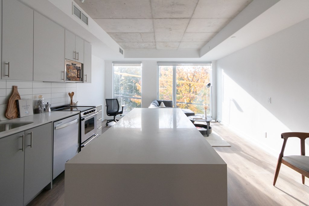 a kitchen and living room with a large island in the middle