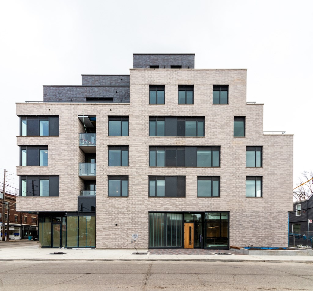 the front of a brick building on a city street