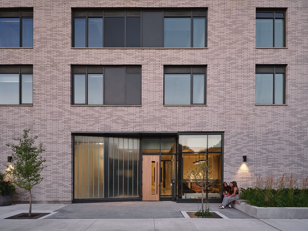 people sitting in front of a brick building