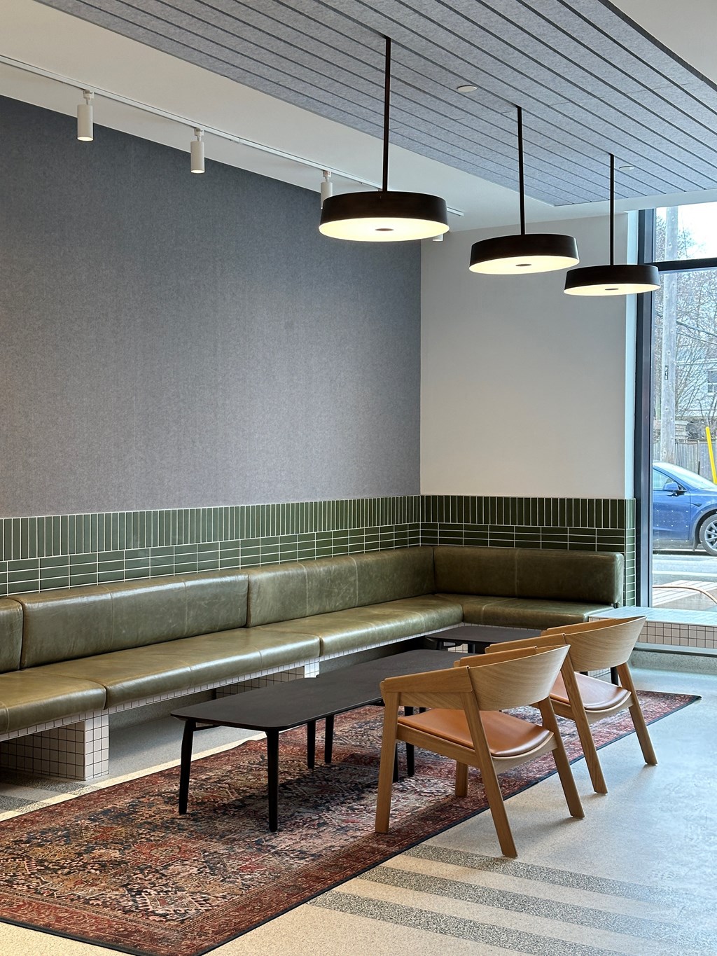 a living room with a table and chairs and a large window