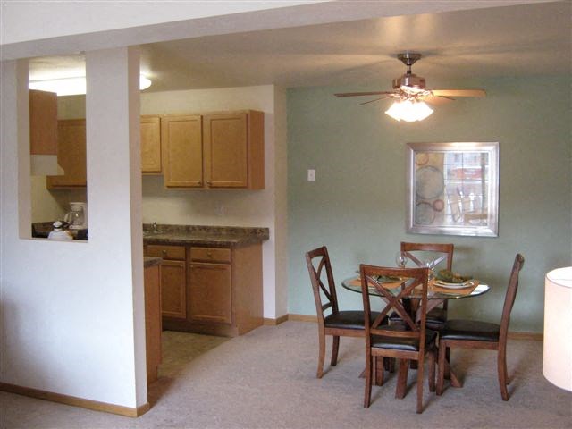 a kitchen and dining room with a table and chairs
