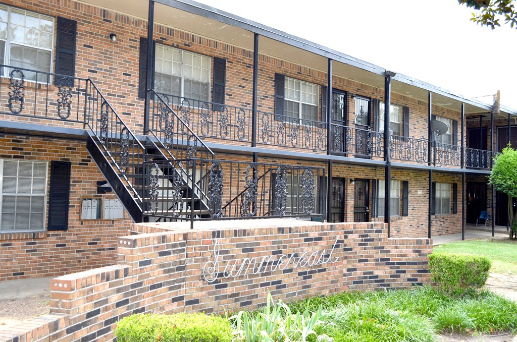 a brick building with black metal railings