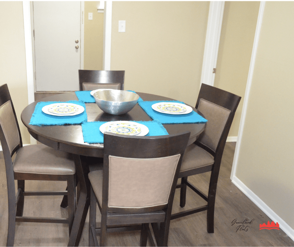 a dining room with a table and chairs