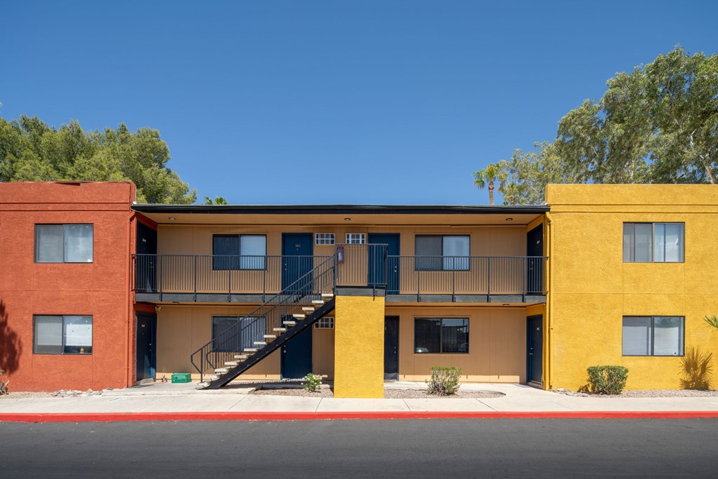 A yellow and red building with a staircase in the middle.