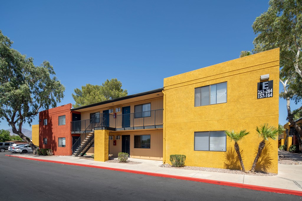A yellow building with a sign that reads 257-764 and 157-164.