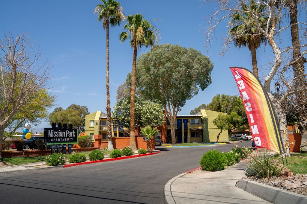 A sign for Mission Park Winery is displayed in front of a building.