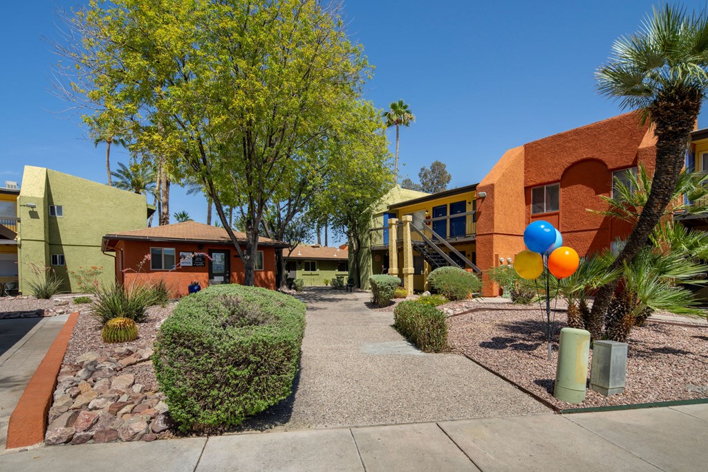A sunny day at a courtyard with a building in the background.