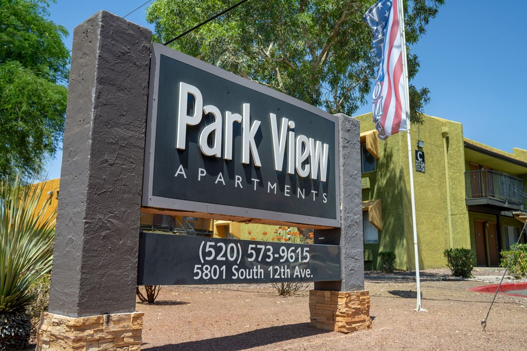 A sign for Park View Apartments is displayed in front of a building.