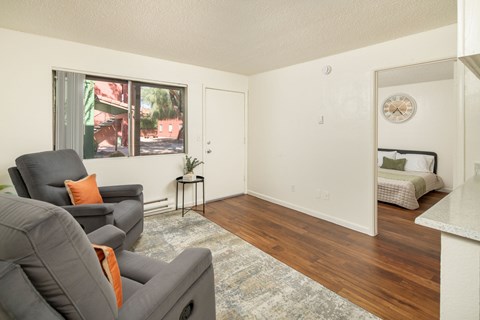A living room with a grey couch and a small table.