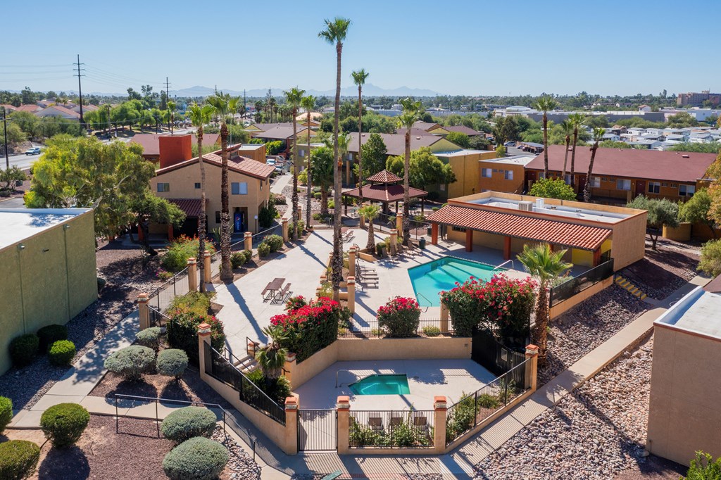 A pool surrounded by a fence with a mountain in the background.