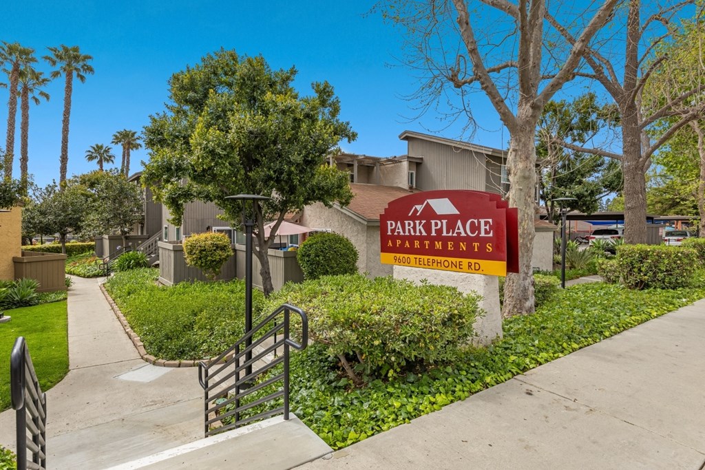 A sign for Park Place Apartments is in front of a building.
