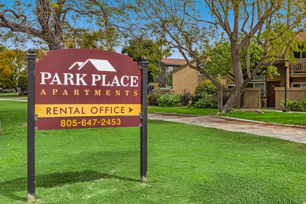 A sign for Park Place Apartments with a rental office and phone number.