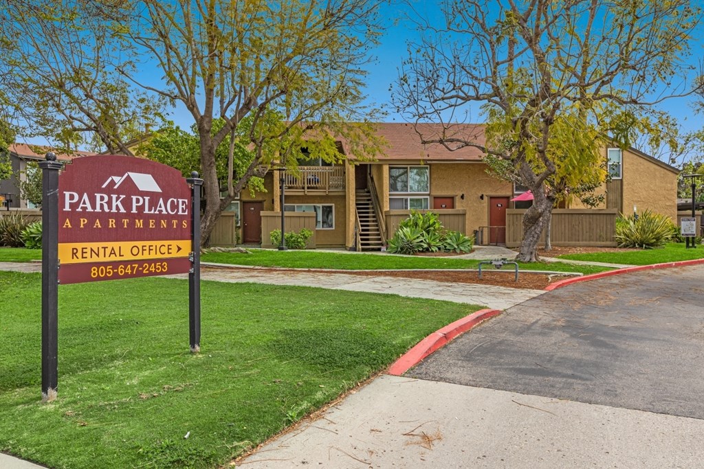 A sign for Park Place Apartments is in front of a building.
