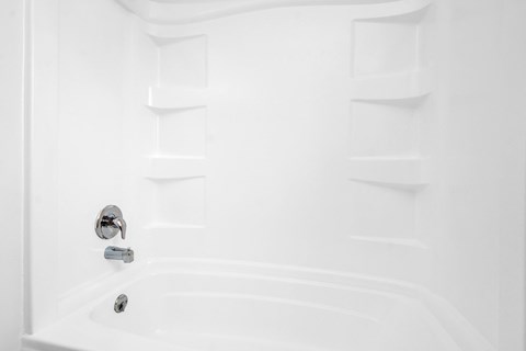 a white bathroom with a shower and a sink
