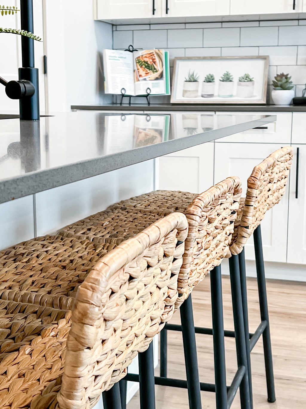 smokey gray quartz counters with white cabinetry and matte black hardware