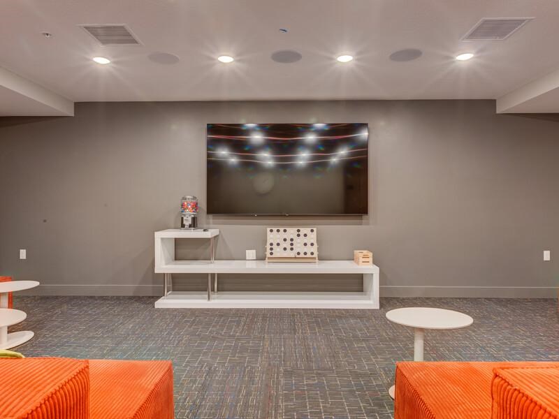 A room with a grey wall and a television mounted on it.