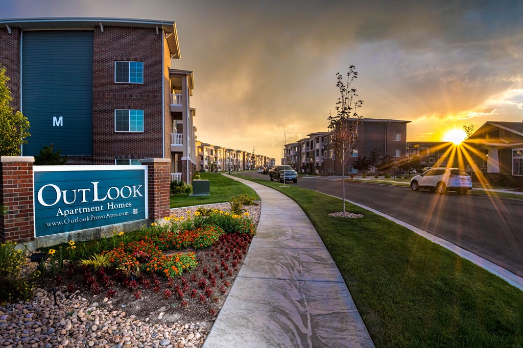 a walkway during sunset along a building at Outlook Apartments for rent in Springville, and Provo Utah.