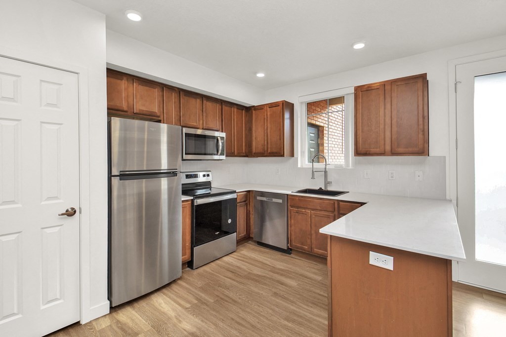 a kitchen with stainless steel appliances and wooden cabinets