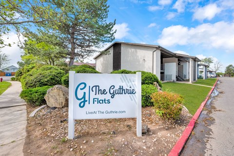 a sign for the gutter flats in front of a building