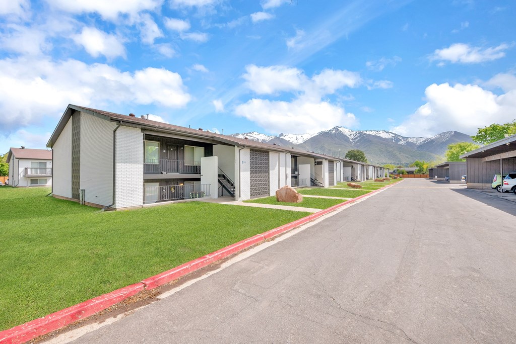 a row of rental houses with mountains in the background