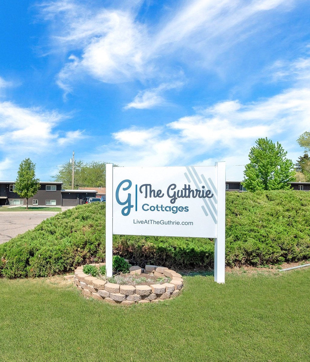 a sign for the gourmet coffees company in front of a grassy field