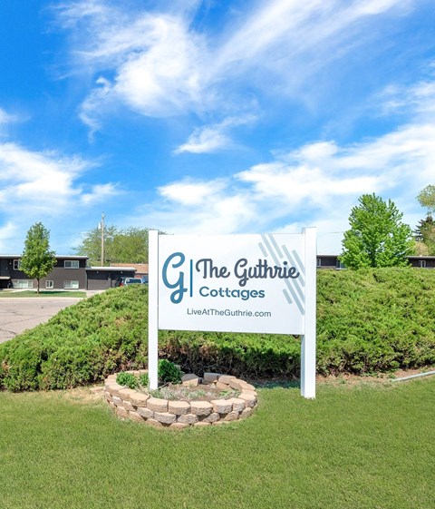 a sign for the gourmet coffees company in front of a grassy field