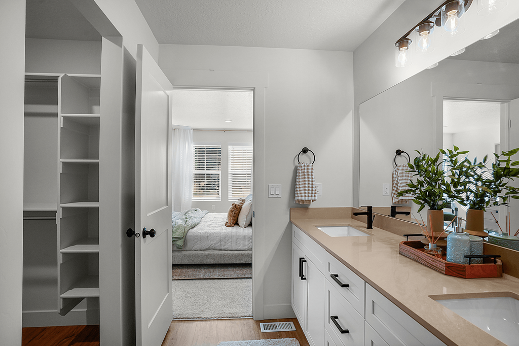 A bathroom with a white door and a white sink.