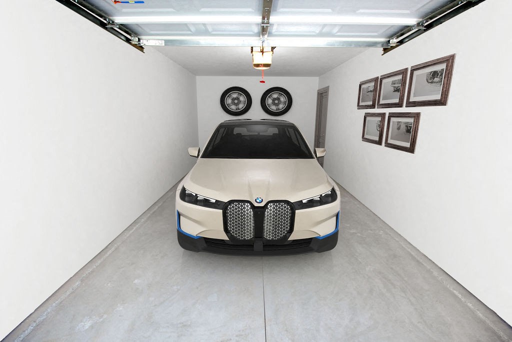 a car parked in a garage with two tires on top of it