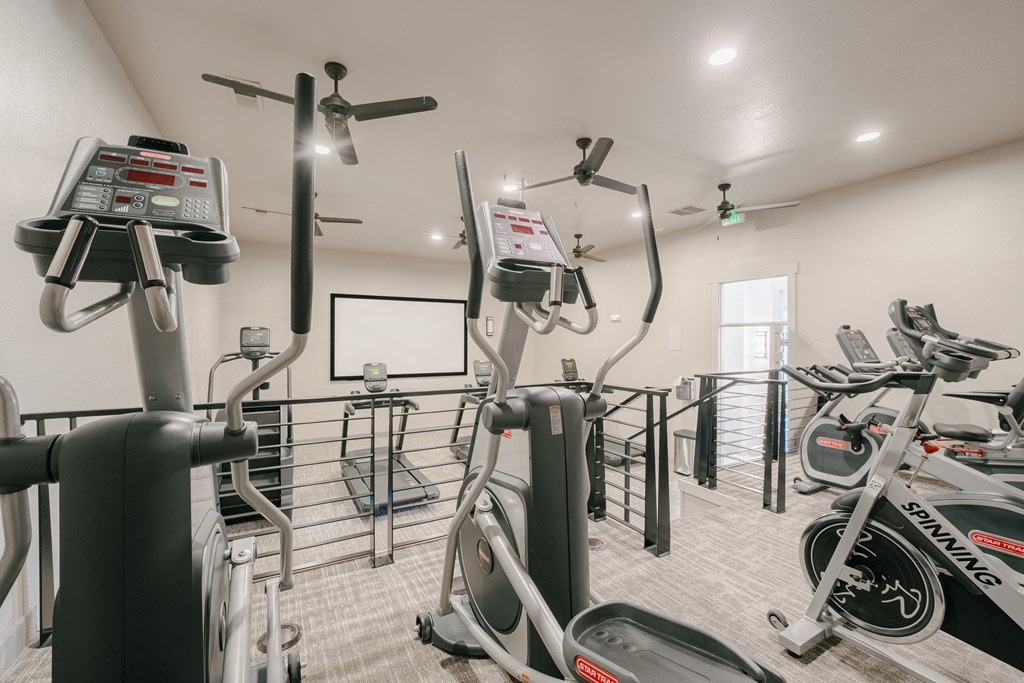a gym with exercise bikes and a chalkboard on the wall at Aldara Apartments in Saratoga Springs, Utah