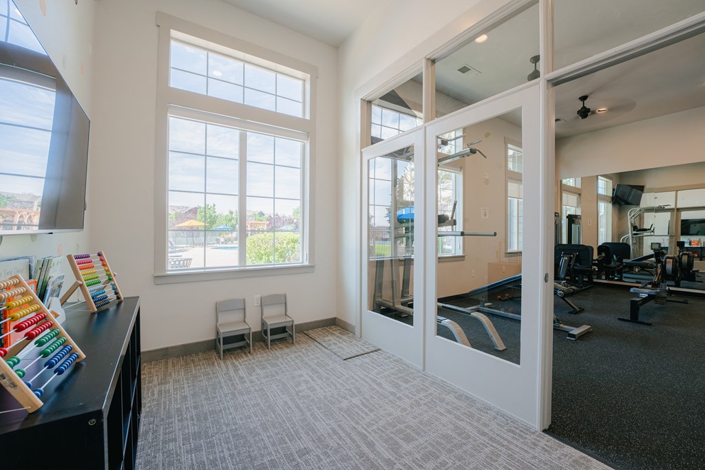 an office with large windows and a desk with chairs at Aldara Apartments in Saratoga Springs, Utah
