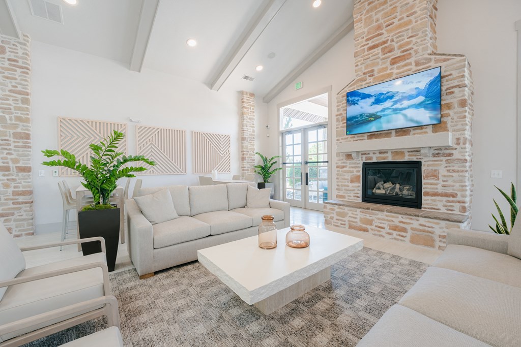 a living room with couches and a coffee table and a fireplace at Aldara Apartments in Saratoga Springs, Utah