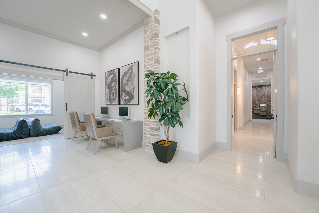 a living room and dining room with a large potted plant at Aldara Apartments in Saratoga Springs, Utah