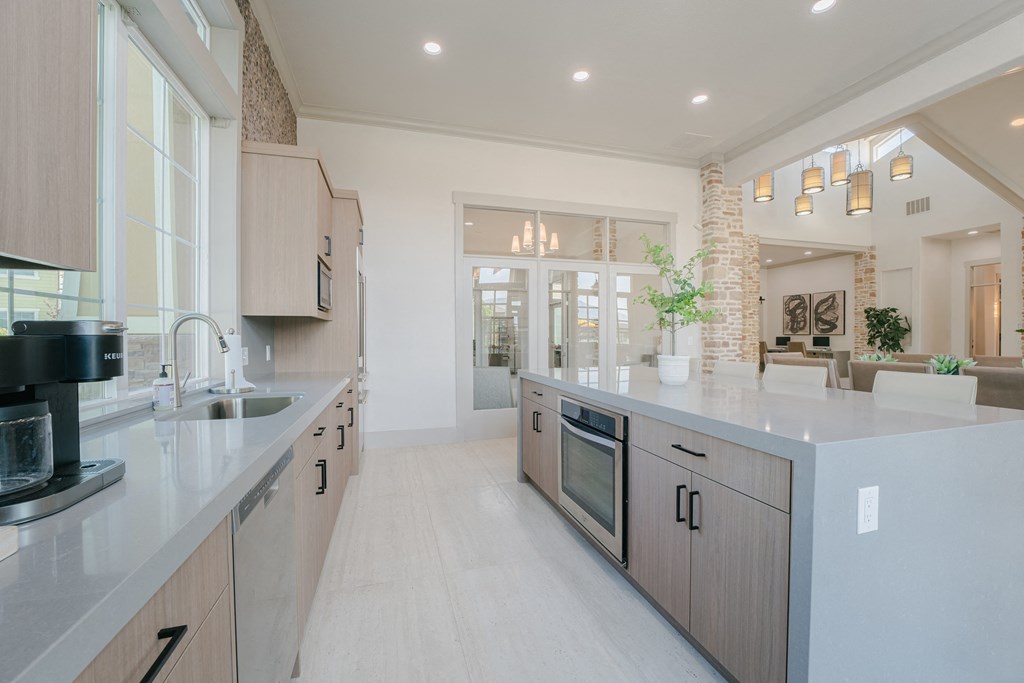 a large kitchen with a sink and a counter top at Aldara Apartments in Saratoga Springs, Utah