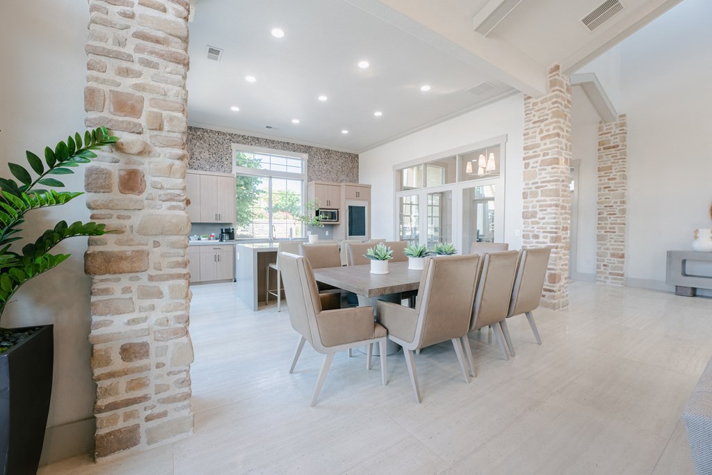 a dining room with a table and chairs in a large room at Aldara Apartments in Saratoga Springs, Utah