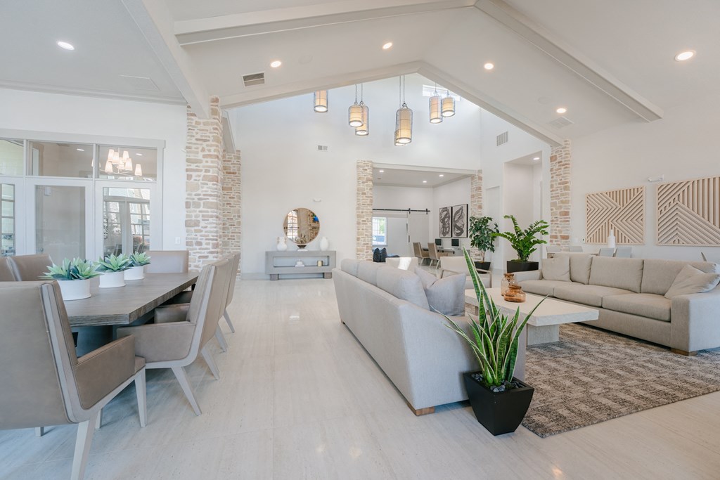a living room and dining room with couches and a table at Aldara Apartments in Saratoga Springs, Utah