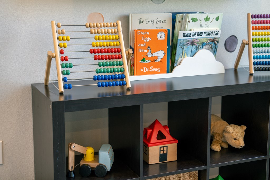 a childrens play room with toys and a wooden abacus at Aldara Apartments in Saratoga Springs, Utah