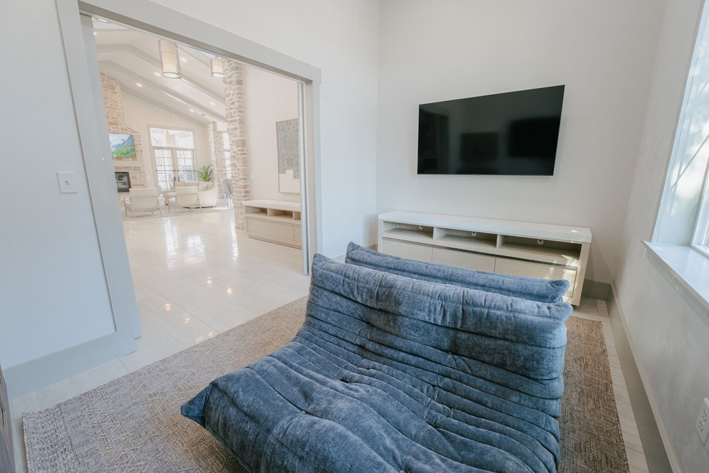 a living room with a blue couch and a tv at Aldara Apartments in Saratoga Springs, Utah