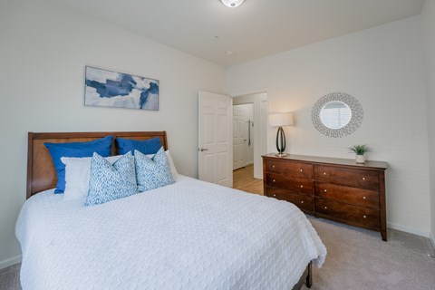 a bedroom with a large bed and a dresser at Aldara Apartments in Saratoga Springs, Utah