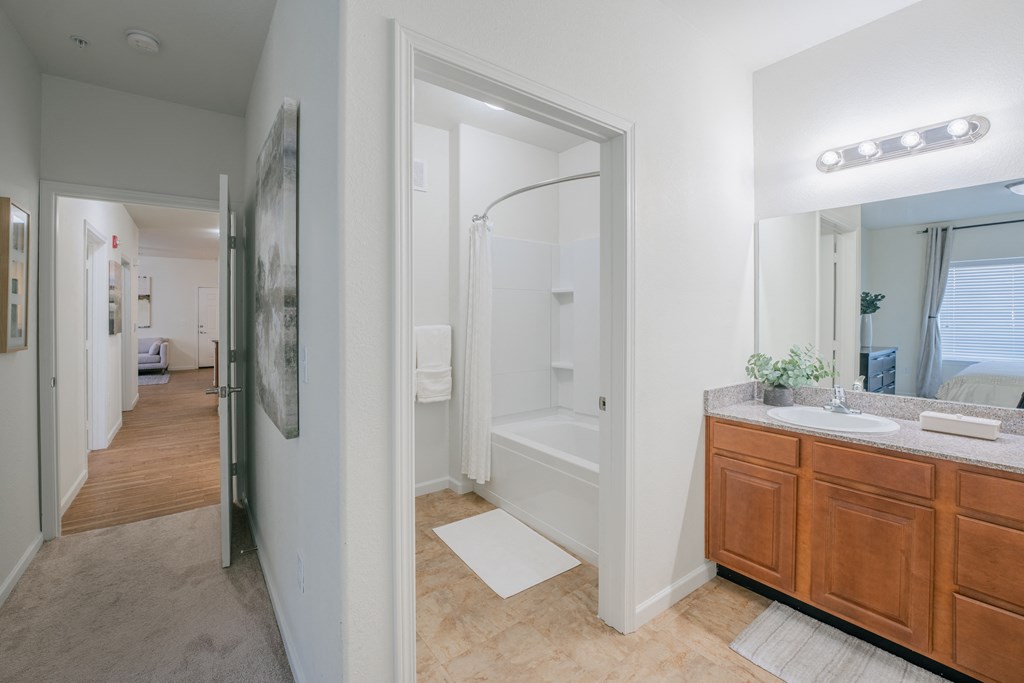 a bathroom with a shower and a sink and a mirror at Aldara Apartments in Saratoga Springs, Utah