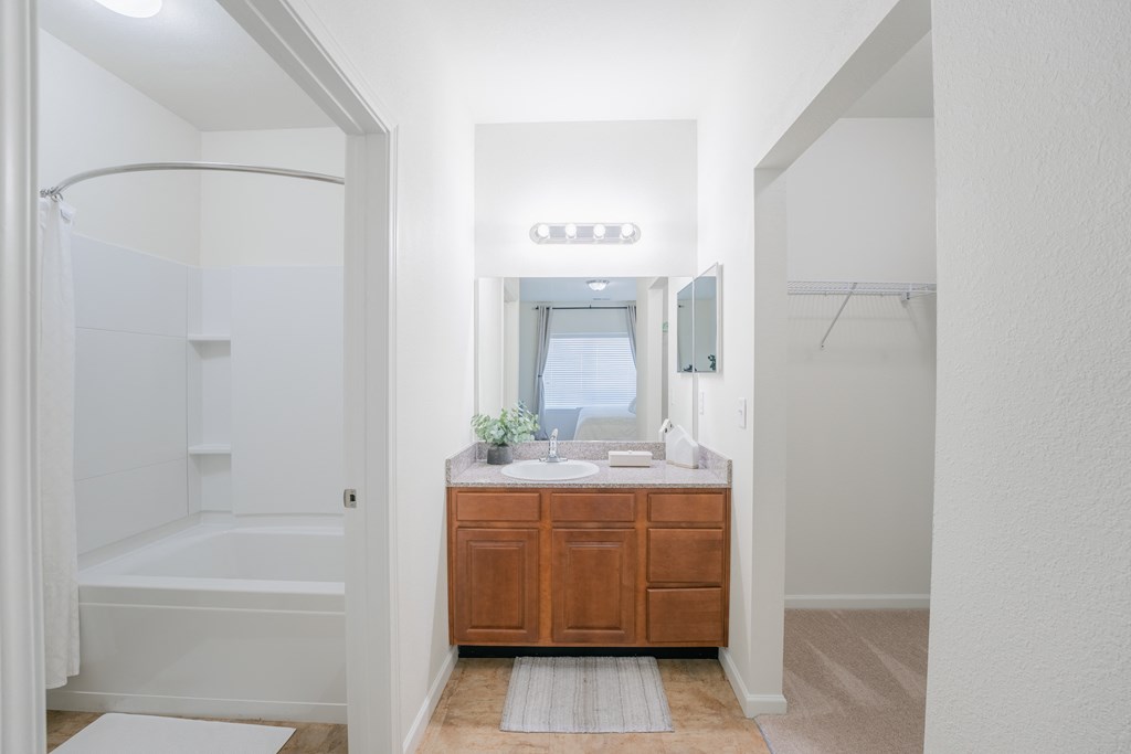 a bathroom with a sink and a shower and a mirror at Aldara Apartments in Saratoga Springs, Utah